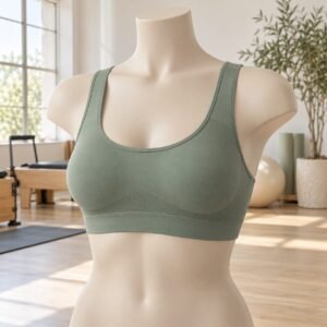 Sage green sports bra on a mannequin in a Pilates studio, OEM sports bra manufacturer from 50 pcs